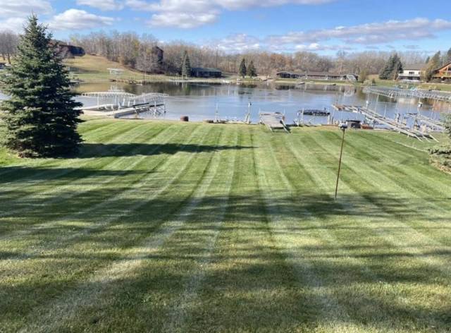 Striped lawn sloping down to the lake and docks